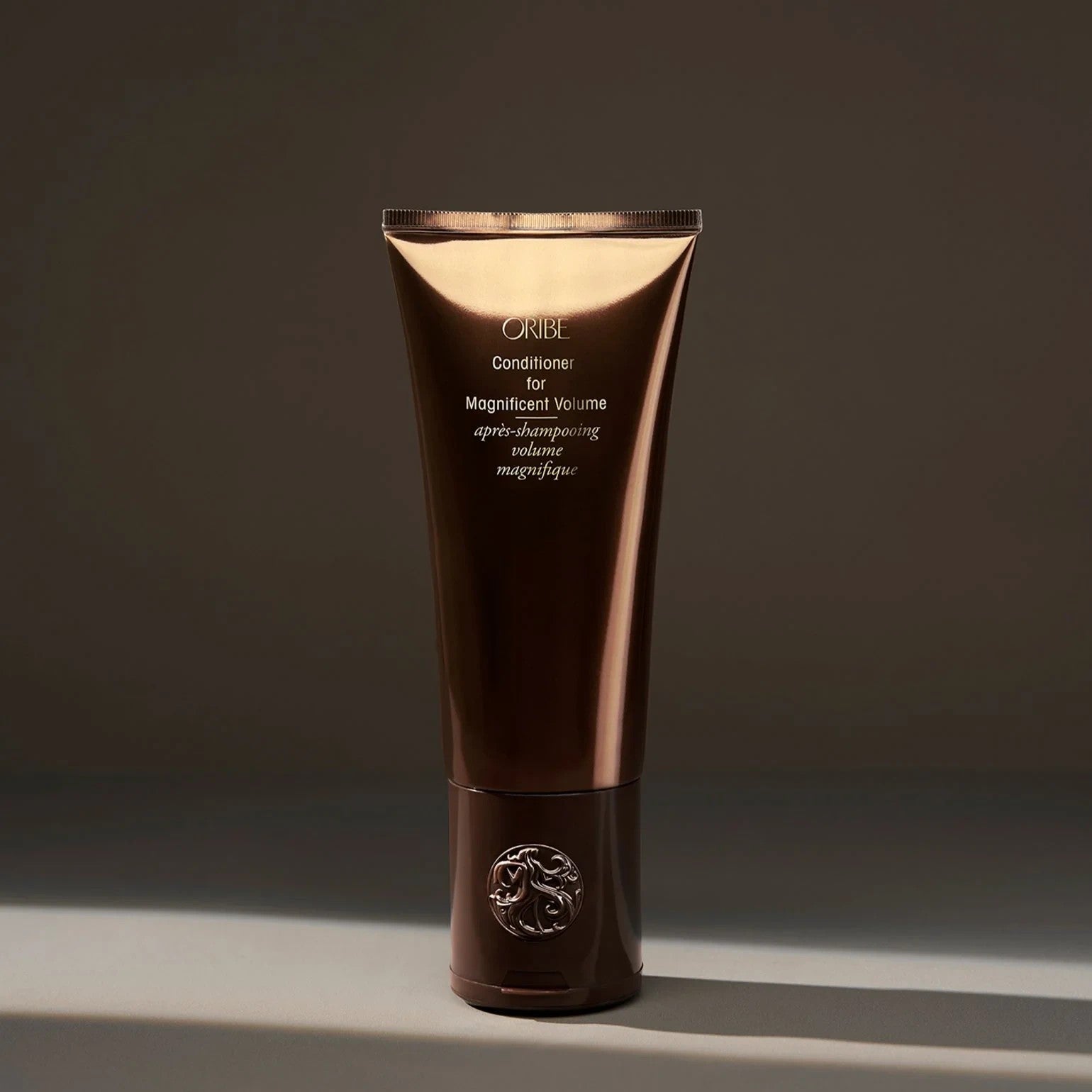 Shop Rescue Spa Oribe Conditioner for Magnificent Volume, a volumizing conditioner for fine to medium hair in a brown tube.