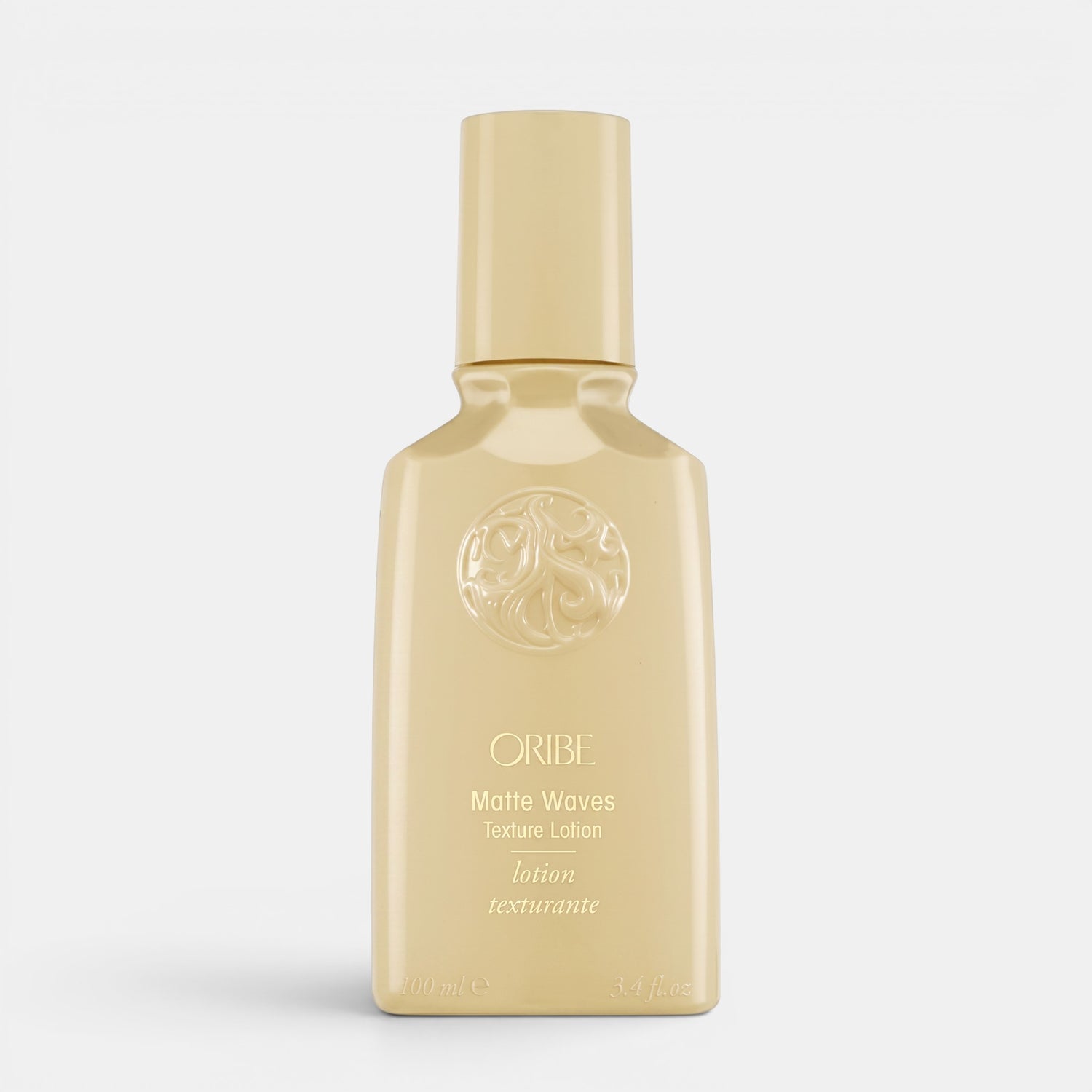Shop Rescue Spa Oribe Matte Waves Texture Lotion in a beige bottle for beachy hair waves and matte finish