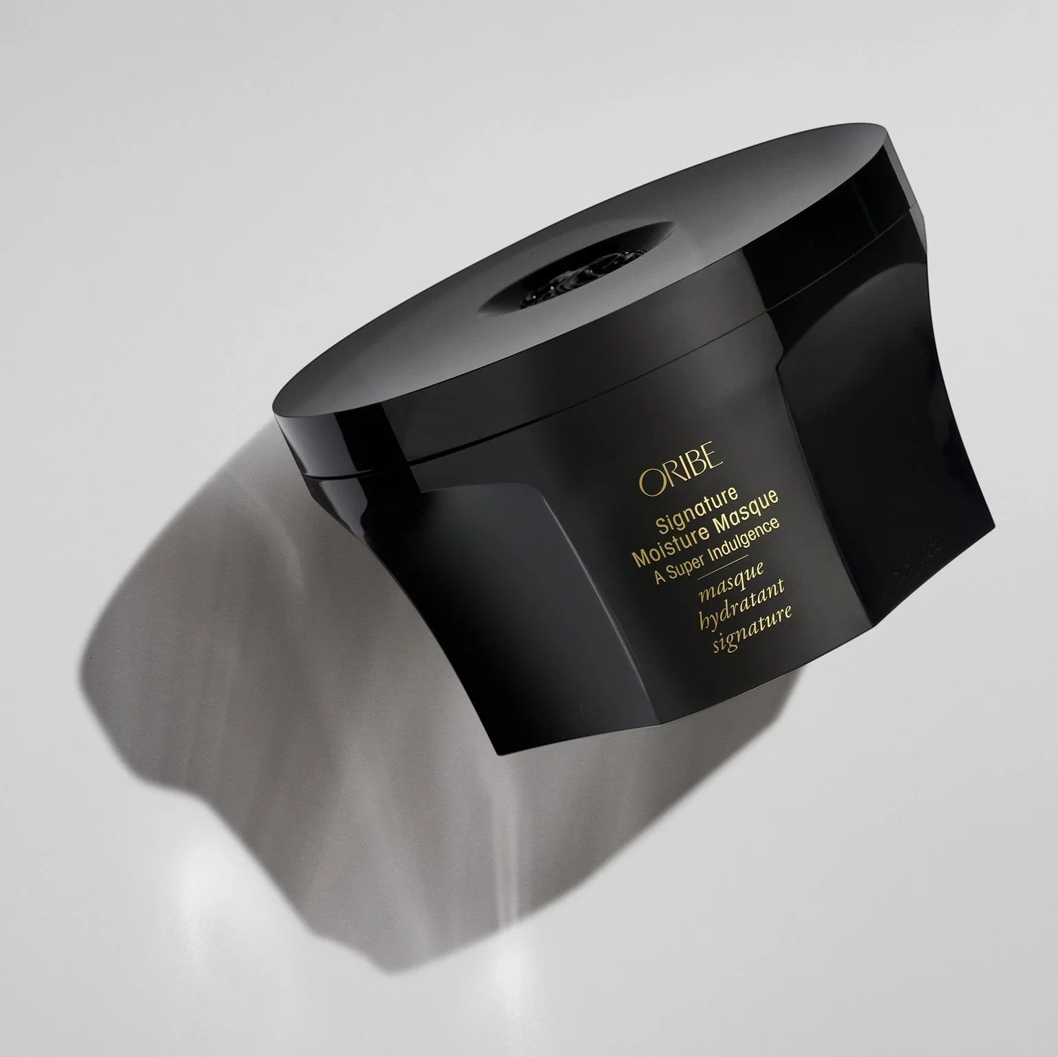 Shop Rescue Spa Oribe Signature Moisture Masque in a black jar for deep hair conditioning and hydration.
