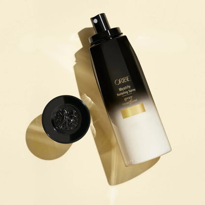 Shop Rescue Spa Oribe Mystify Restyling Spray bottle with black cap, protects hair from heat.