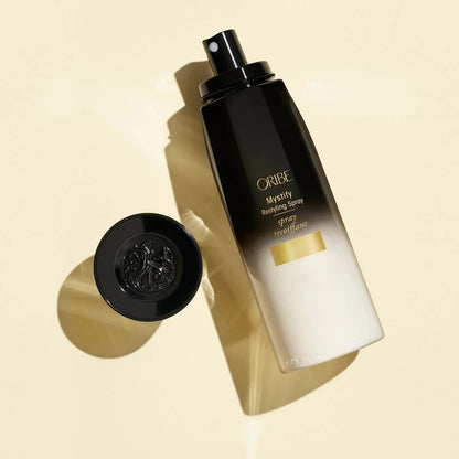 Shop Rescue Spa Oribe Mystify Restyling Spray bottle with black cap, protects hair from heat.