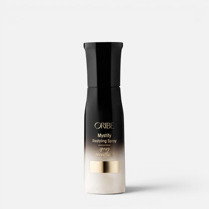 Shop Rescue Spa Oribe Mystify Restyling Spray bottle with black and gold gradient packaging for heat protection.