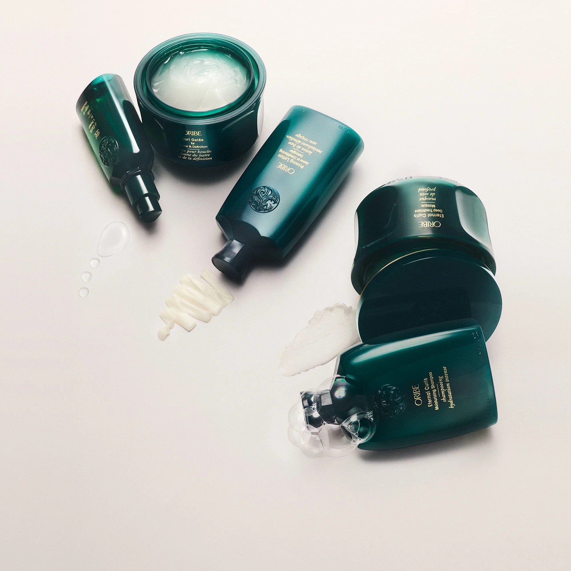 Shop Rescue Spa Oribe Priming Lotion Leave In Conditioning Detangler for curls, 8.5 oz. Silky, green bottles with white product textures.