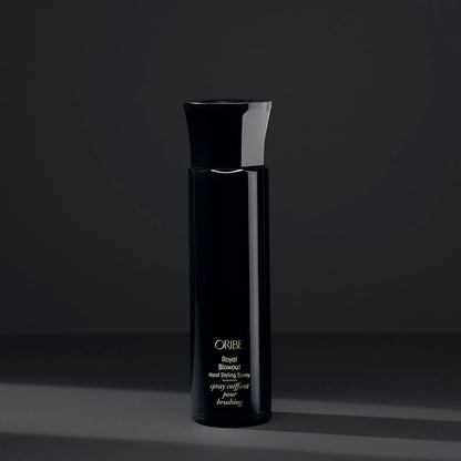 Shop Rescue Spa Oribe Royal Blowout heat styling spray in a sleek black bottle against a dark grey background.