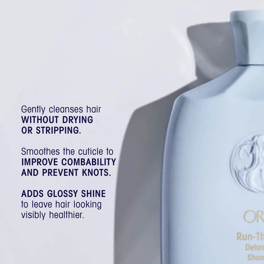 Shop Rescue Spa Oribe Run-Through Detangling Shampoo bottle, light blue, for all hair types, adds shine and moisture.