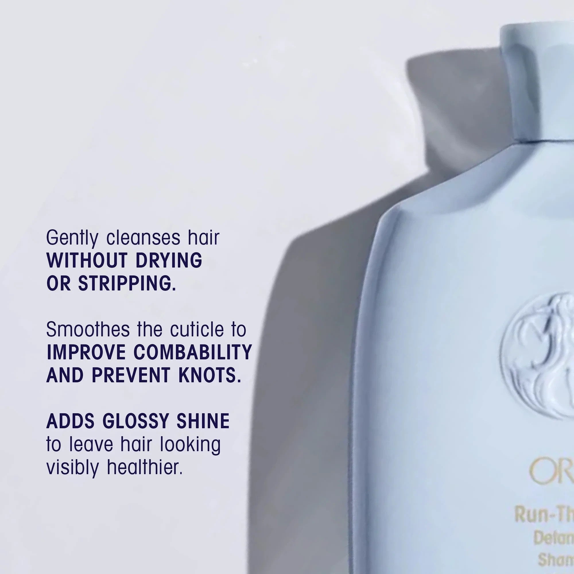 Shop Rescue Spa Oribe Run-Through Detangling Shampoo bottle, light blue, for all hair types, adds shine and moisture.