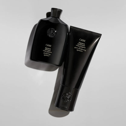 Shop Rescue Spa Oribe Signature Shampoo and Conditioner set in black bottles for daily hair nourishment.