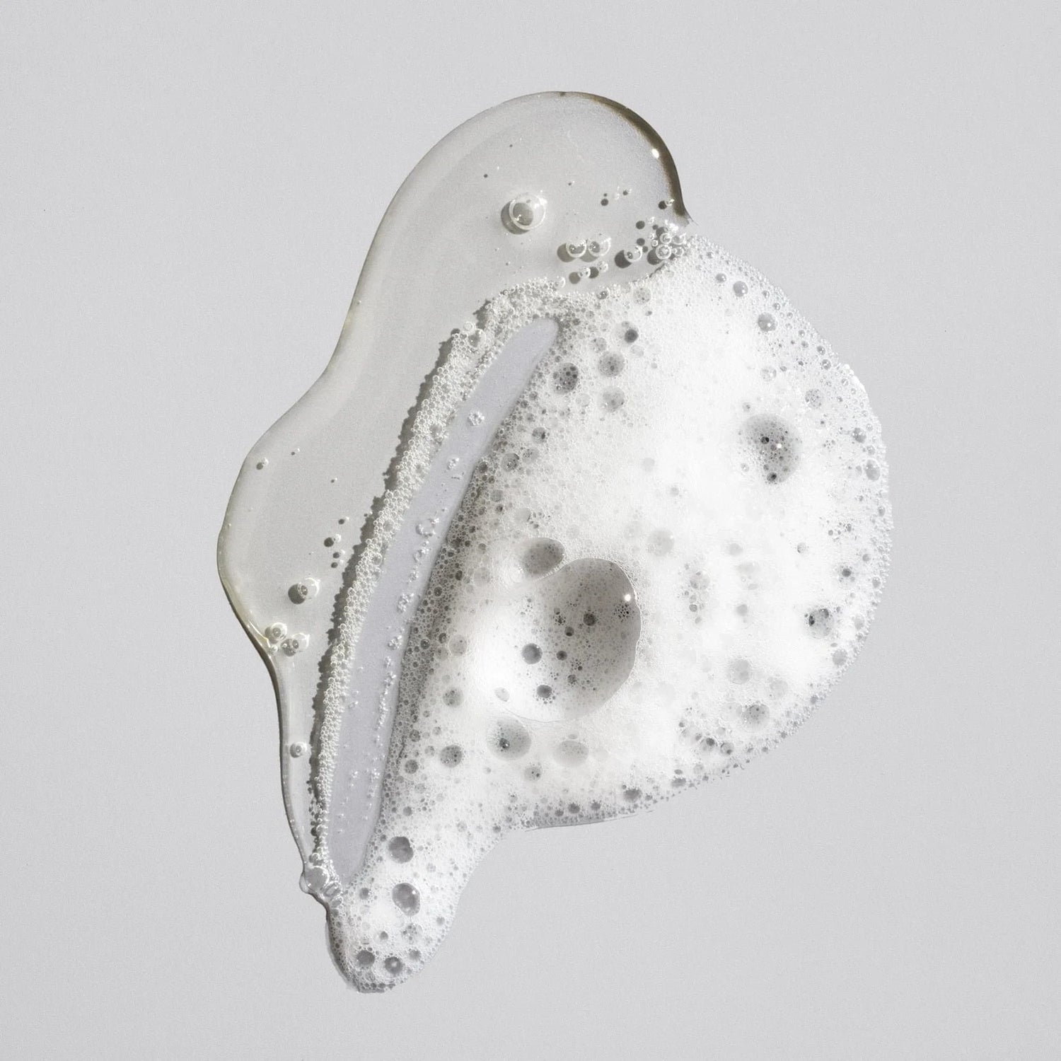 Shop Rescue Spa Oribe Signature Shampoo clear gel texture with white lather bubbles on a neutral background
