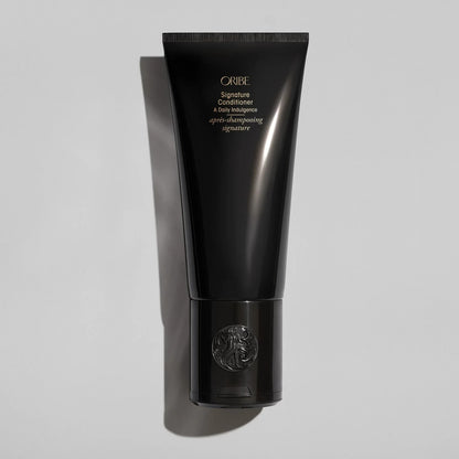 Shop Rescue Spa Oribe Signature Conditioner in a sleek black tube for restorative and moisturizing hair care.