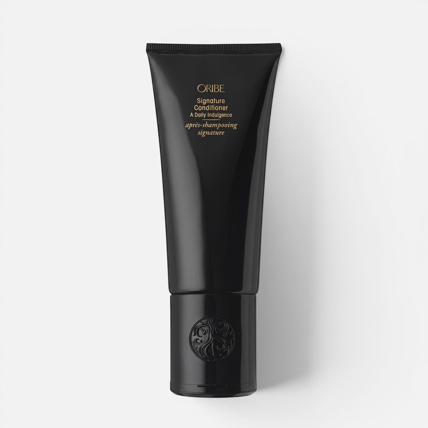 Shop Rescue Spa Oribe Signature Conditioner in a sleek black squeeze tube for restorative hair hydration.