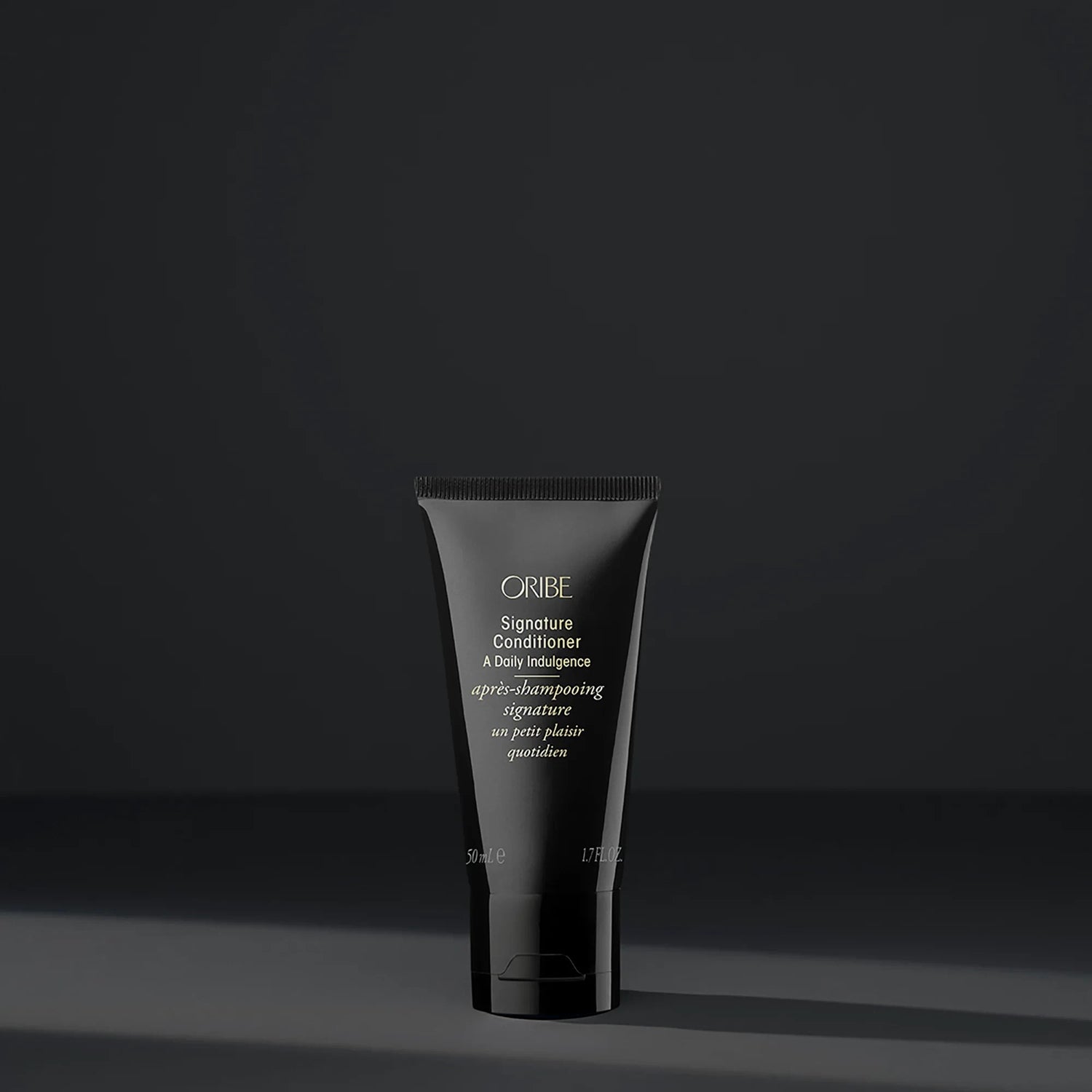 Shop Rescue Spa Oribe Signature Conditioner in a sleek black 50ml travel-size tube for daily hair moisturizing.