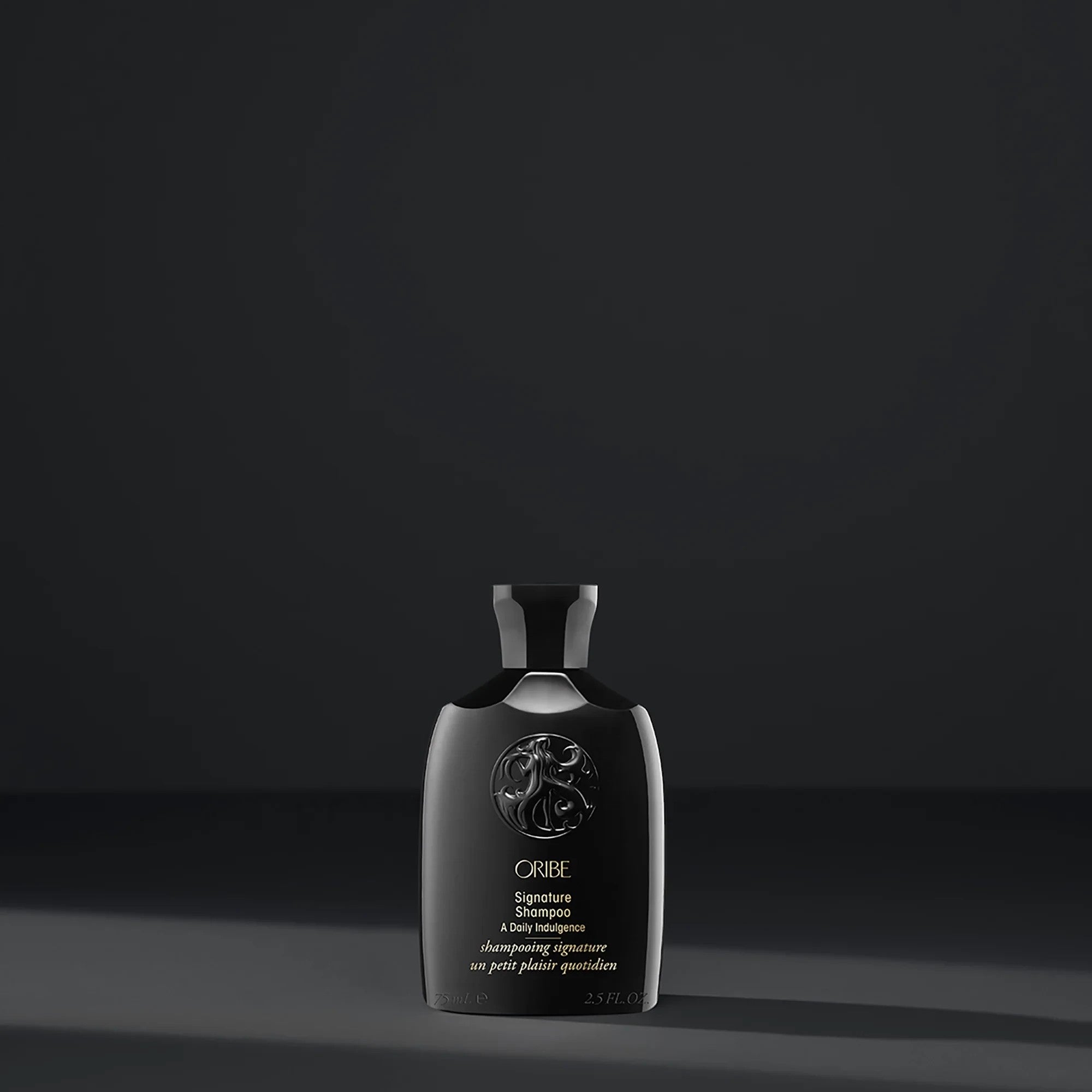 Shop Rescue Spa Oribe Signature Shampoo travel size bottle in black packaging with elegant embossed logo