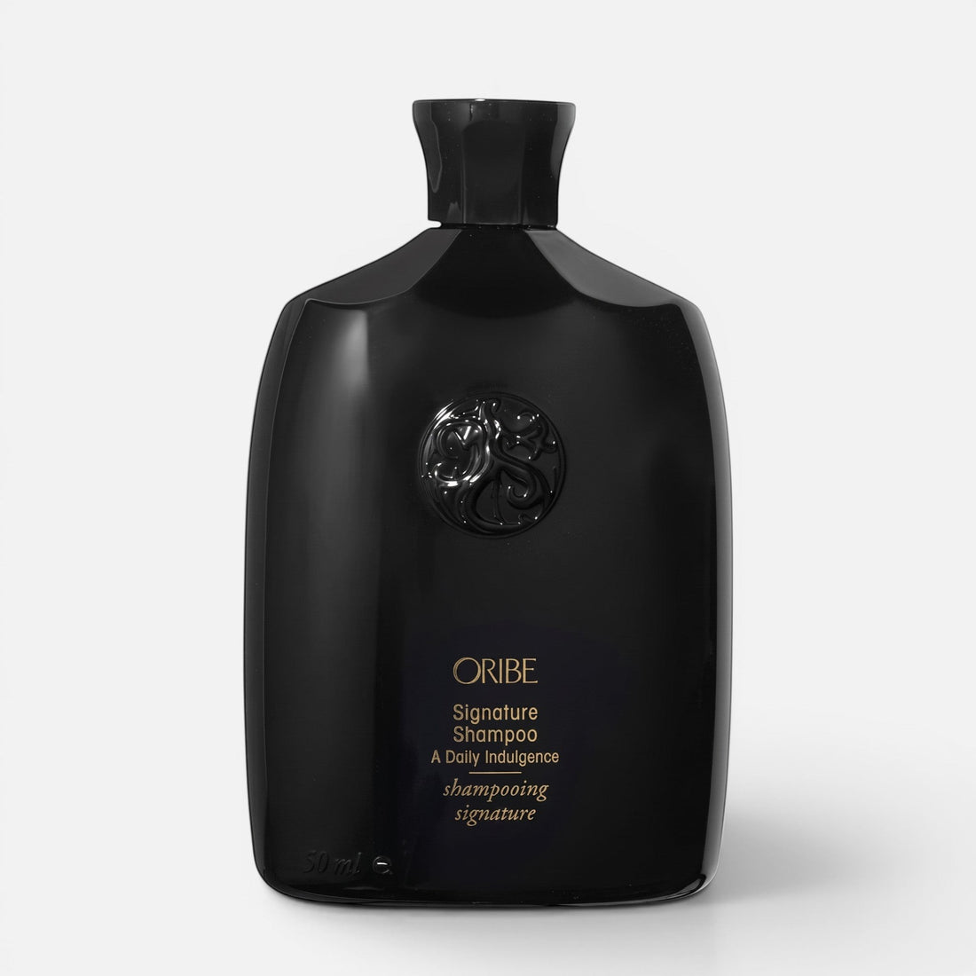 Shop Rescue Spa Oribe Signature Shampoo in a sleek black bottle with gold lettering for daily hair nourishment.