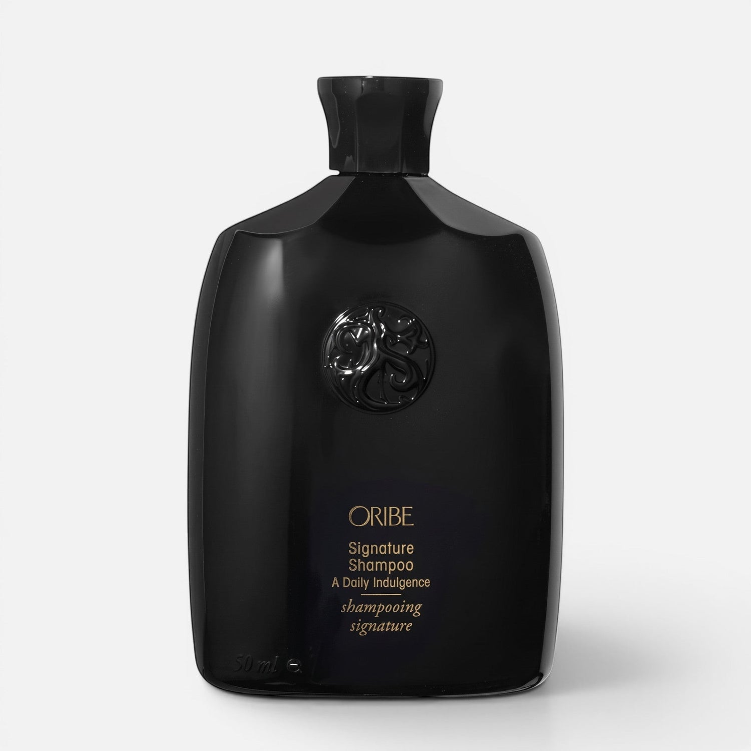 Shop Rescue Spa Oribe Signature Shampoo in a sleek black bottle with gold lettering for daily hair nourishment.