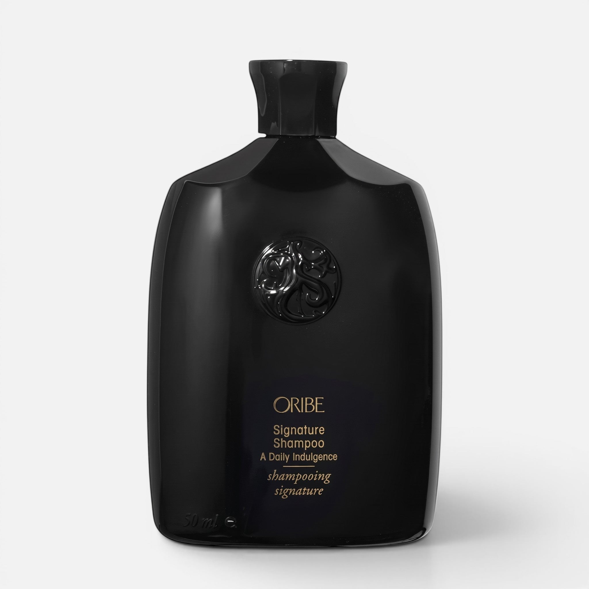 Shop Rescue Spa Oribe Signature Shampoo in a sleek black bottle with gold lettering for daily hair nourishment.