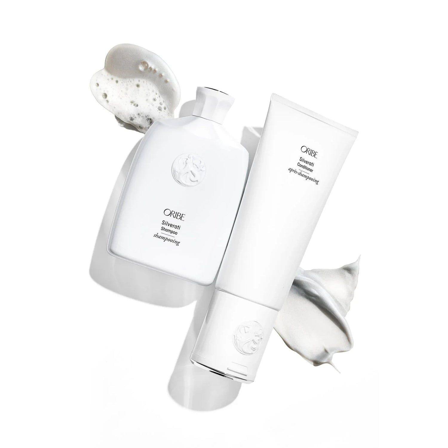 Shop Rescue Spa ORIBE Silverati Conditioner tube with white cream swatch and ORIBE Silverati Shampoo bottle with foam swatch.