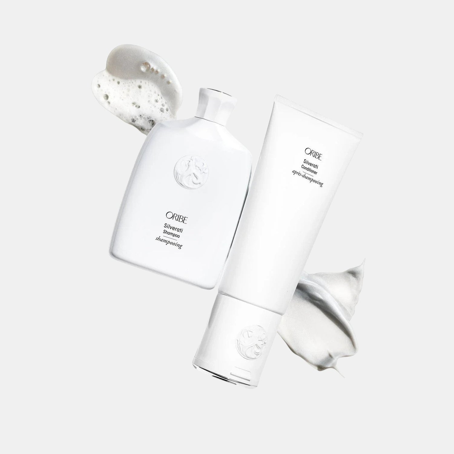 Shop Rescue Spa ORIBE Silverati Conditioner tube with white cream swatch and ORIBE Silverati Shampoo bottle with foam swatch.