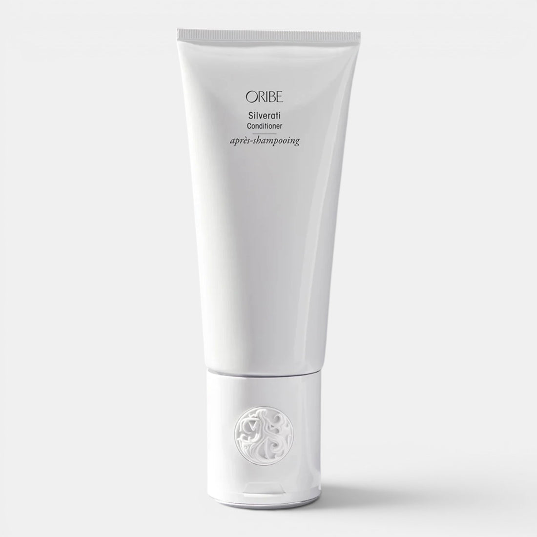 Shop Rescue Spa ORIBE Silverati Conditioner tube, a white bottle with black text, designed to brighten silver hair and banish dullness.