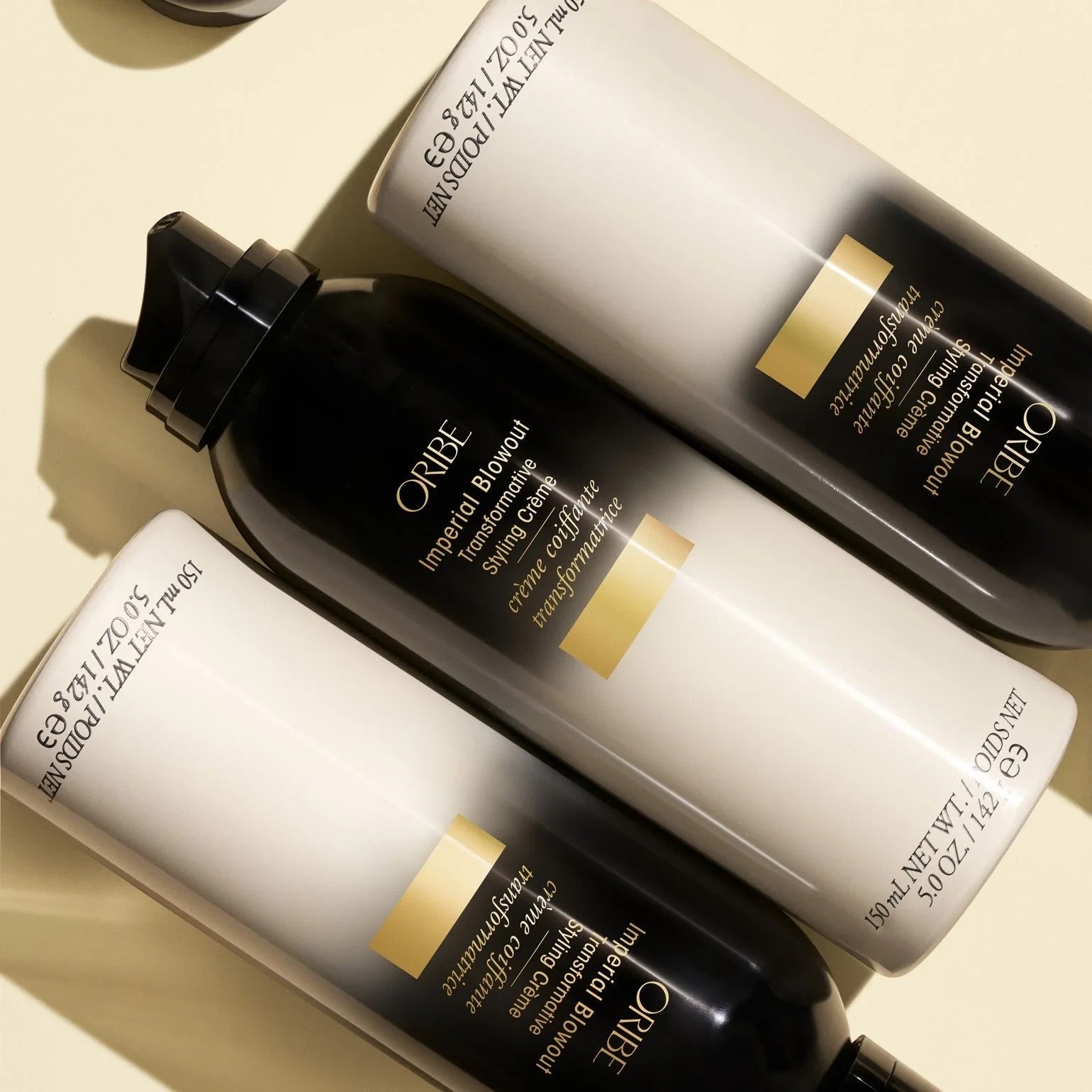 Shop Rescue Spa Oribe Imperial Blowout Transformative Styling Creme bottles in a flat lay arrangement