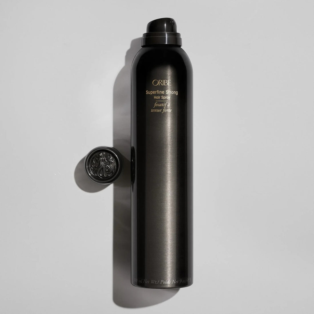 Shop Rescue Spa ORIBE Superfine Strong Hair Spray bottle with ornate cap, providing strong hold and natural shine.