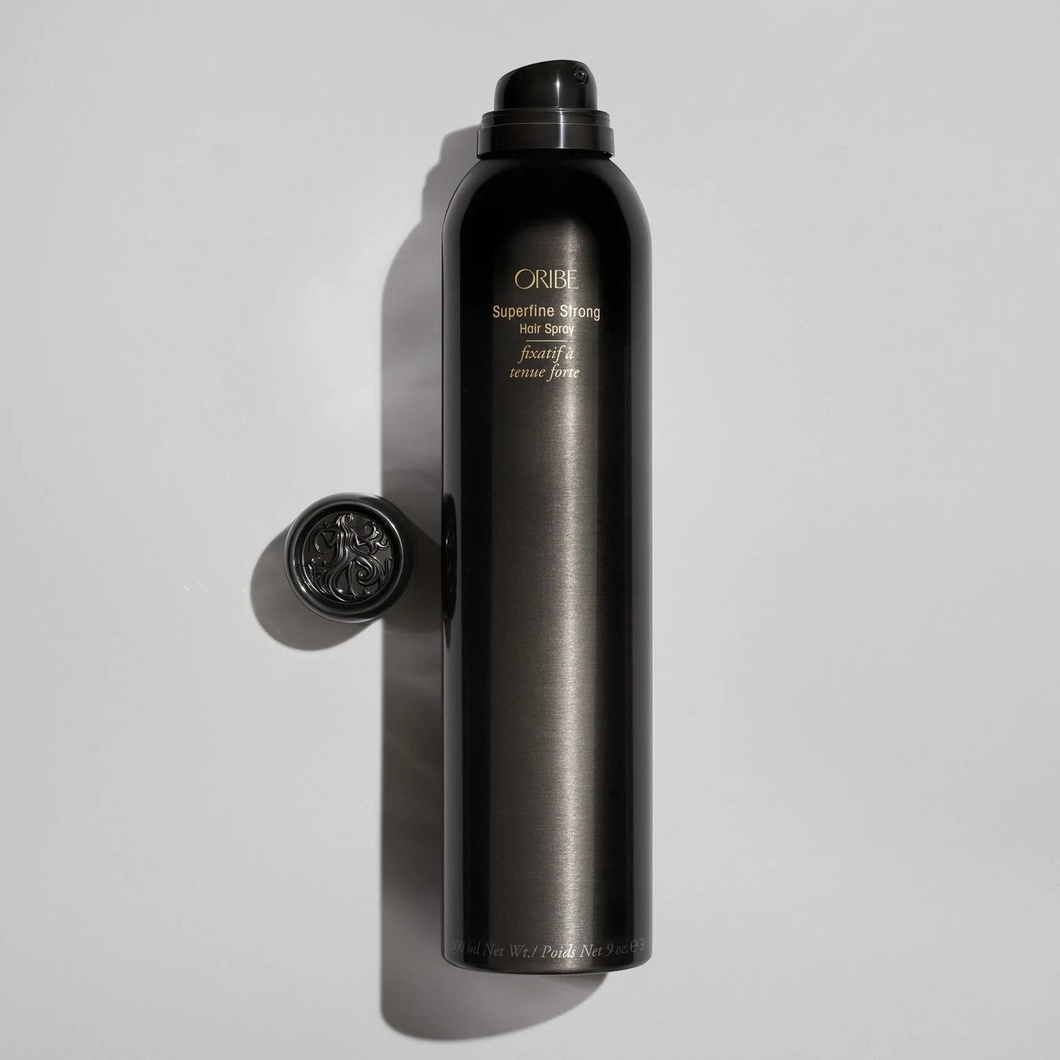 Shop Rescue Spa ORIBE Superfine Strong Hair Spray bottle with ornate cap, providing strong hold and natural shine.