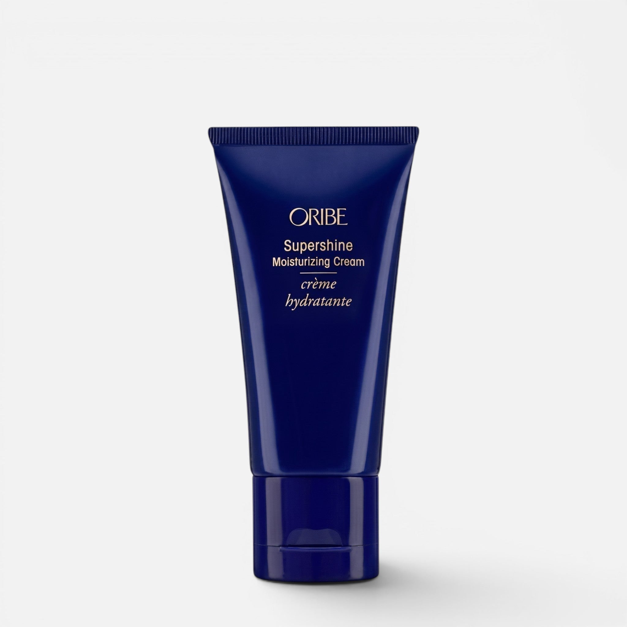 Shop Rescue Spa Oribe Supershine Moisturizing Cream in a dark blue squeeze tube for hydrating and smoothing hair.