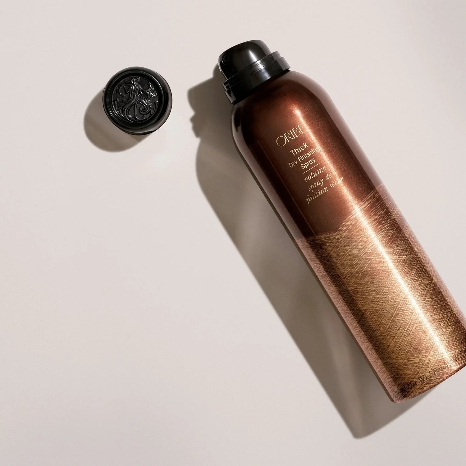 Shop Rescue Spa Oribe Thick Dry Finishing Spray bottle with black cap, adds volume and thickness to hair.