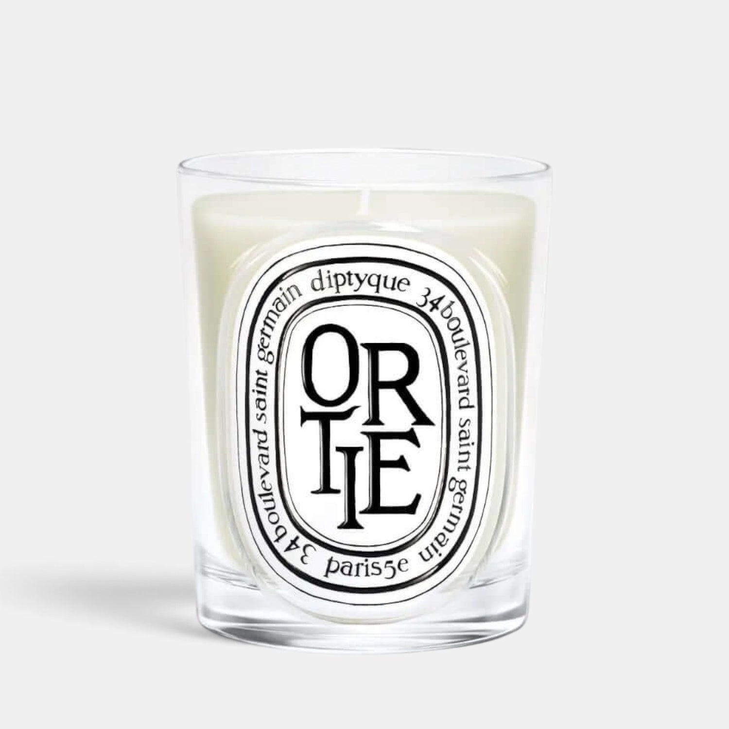Shop Rescue Spa Ortie scented candle in a clear glass vessel with a signature oval label featuring green wax.