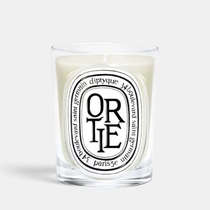 Shop Rescue Spa Ortie scented candle in a clear glass vessel with a signature oval label featuring green wax.