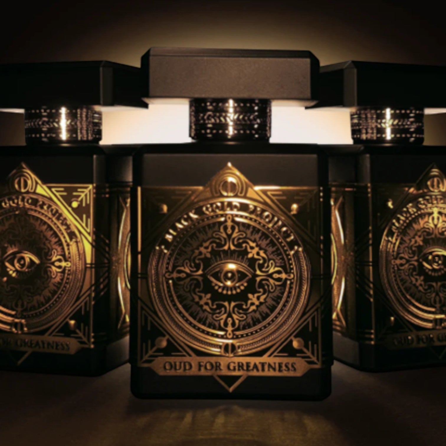 Shop Rescue Spa Oud For Greatness Eau De Parfum 90ml, black bottle with gold ornate detailing and an eye emblem.
