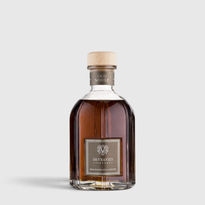 Shop Rescue Spa Oud Nobile room diffuser in a glass bottle with a wooden cap and amber fragrance oil.
