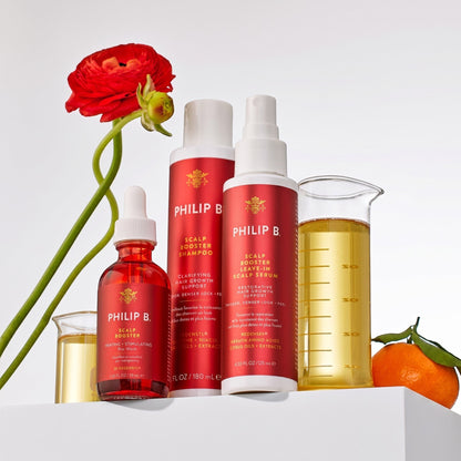 Shop Rescue Spa Philip B Scalp Booster hair care collection with pre-wash, shampoo, and serum bottles on a white stand.