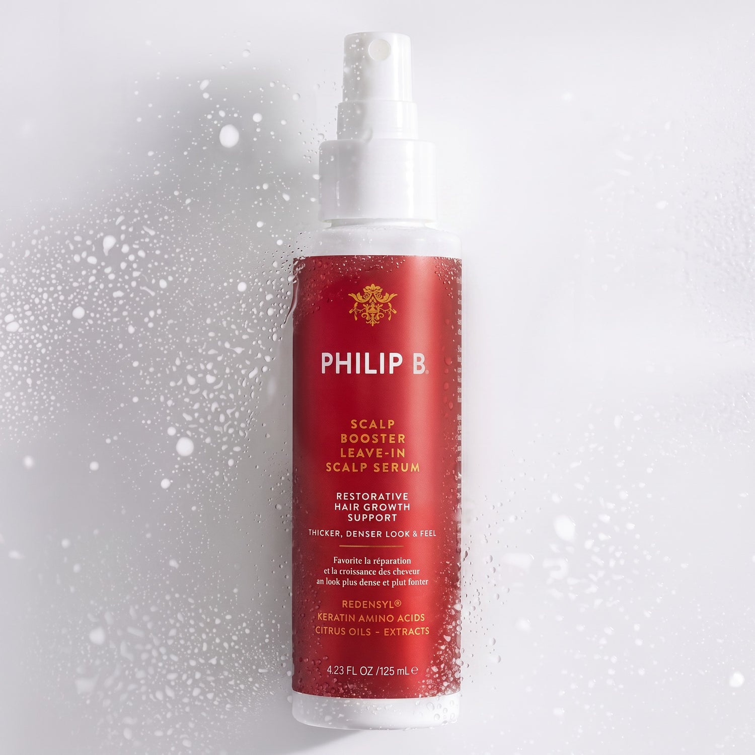 Shop Rescue Spa Philip B. Scalp Booster leave-in serum bottle with water droplets on a white background.