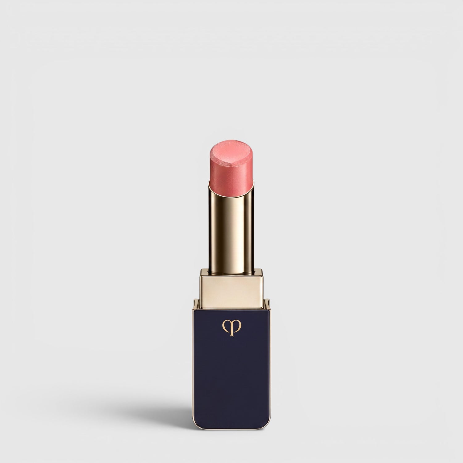 Shop Rescue Spa Lipstick Shine in a soft pink shade with a luminous dewy finish in a sleek navy and gold tube.