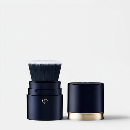 Shop Rescue Spa portable foundation brush with dense, silky synthetic fibers and a navy case with gold accent.