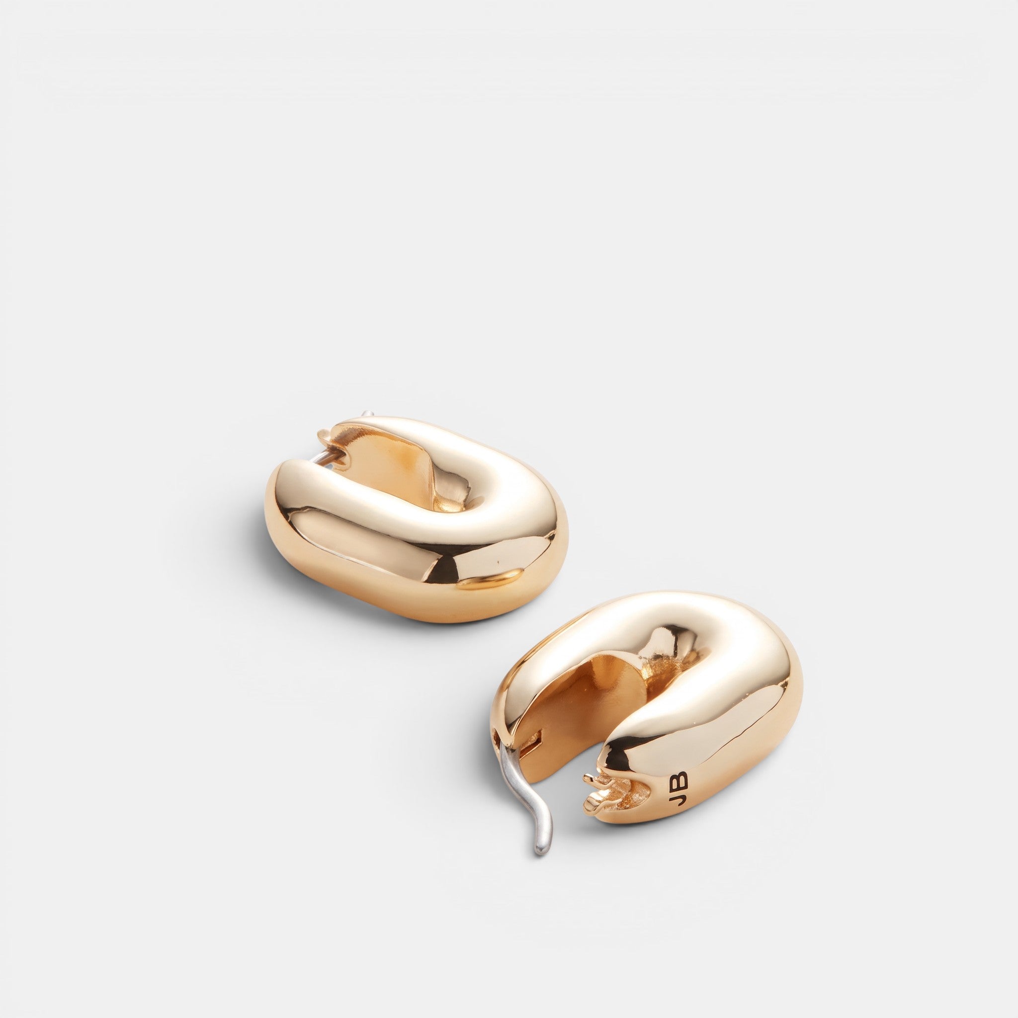 Shop Rescue Spa puffy gold U-link hoop earrings with a high-polish finish and secure hinge closure.