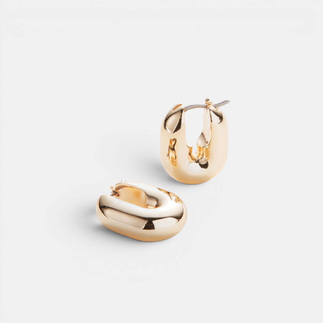 Shop Rescue Spa puffy gold U-link hoop earrings with a high-polish finish and convenient hinged closure.