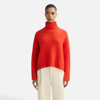 Model wearing a Shop Rescue Spa chunky red cashmere turtleneck sweater with sleeve slits and a relaxed fit.