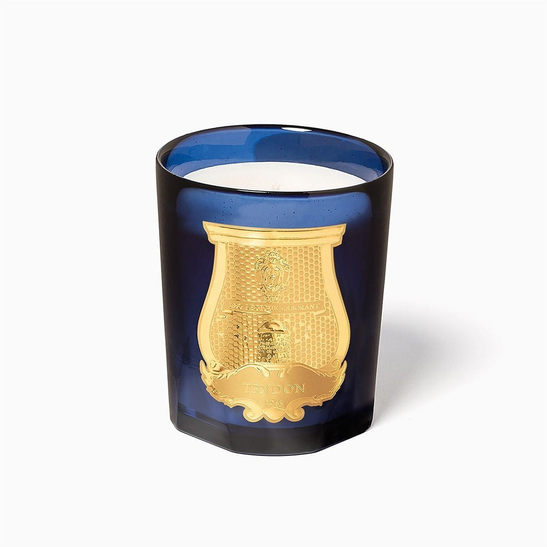 Shop Rescue Spa Reggio Classic Candle in a deep blue glass vessel with an ornate gold emblem