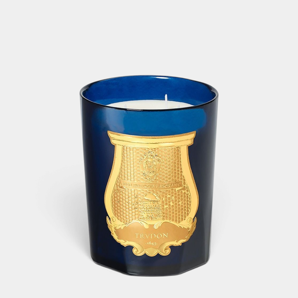 Shop Rescue Spa Reggio Intermezzo 800g candle in a deep blue glass vessel with a gold embossed crest label