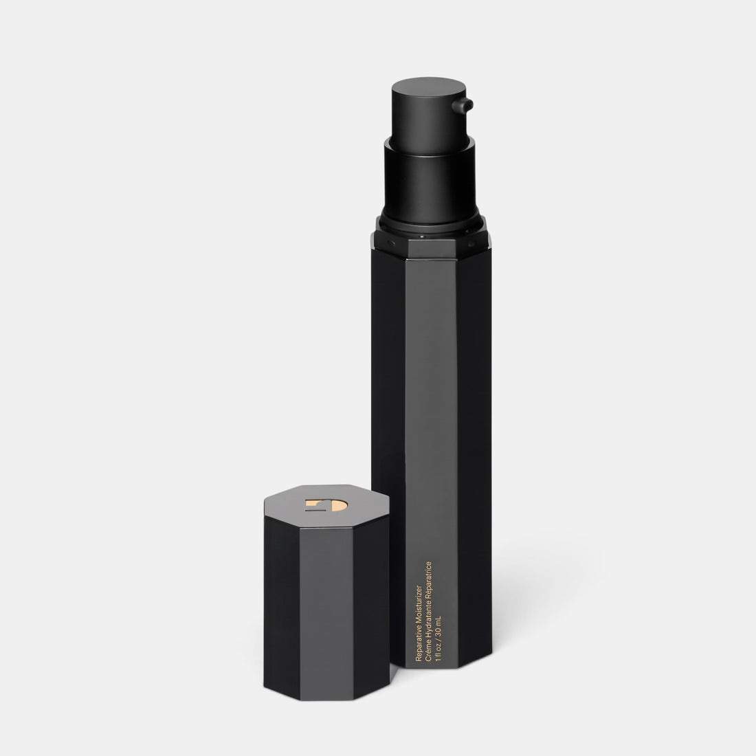 Shop Rescue Spa The Reparative Moisturizer in a sleek black hexagonal pump bottle with its cap removed.