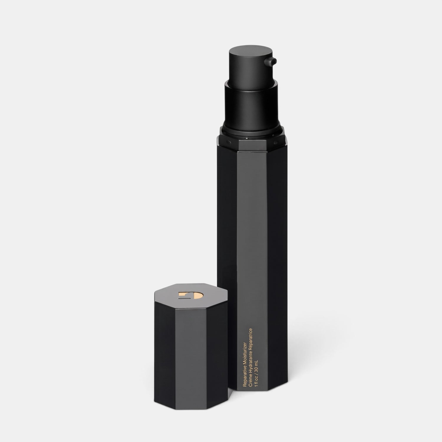 Shop Rescue Spa The Reparative Moisturizer in a sleek black hexagonal pump bottle with its cap removed.