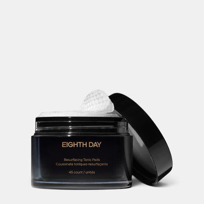 Shop Rescue Spa Eighth Day Resurfacing Tonic Pads in a black jar with one textured exfoliating pad on top
