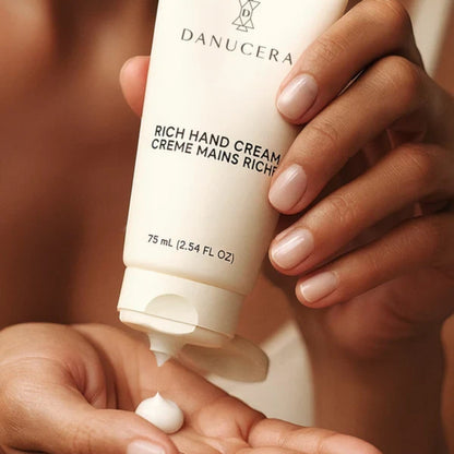 Shop Rescue Spa Danucera Rich Hand Cream being dispensed onto a palm for intensive repair and hydration.