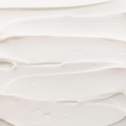 Shop Rescue Spa Rich Hand Cream texture showing a smooth, thick white moisturizing cream spread in soft swirls.