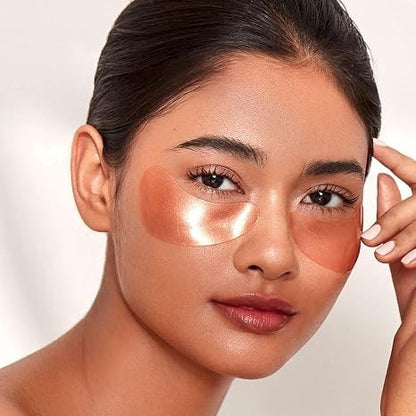 Shop Rescue Spa rose gold hydrogel eye mask applied under the eyes of a woman for brightening and radiance