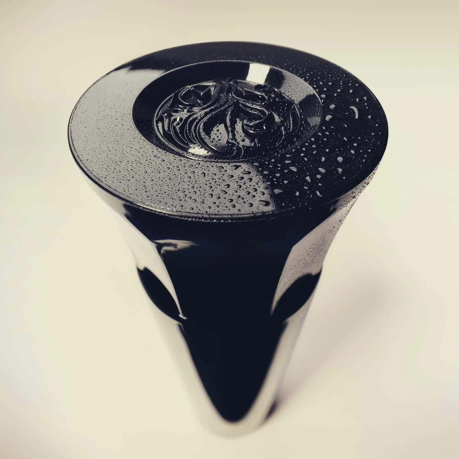 Shop Rescue Spa Royal Blowout Heat Styling Spray bottle cap with water droplets on a sleek black surface