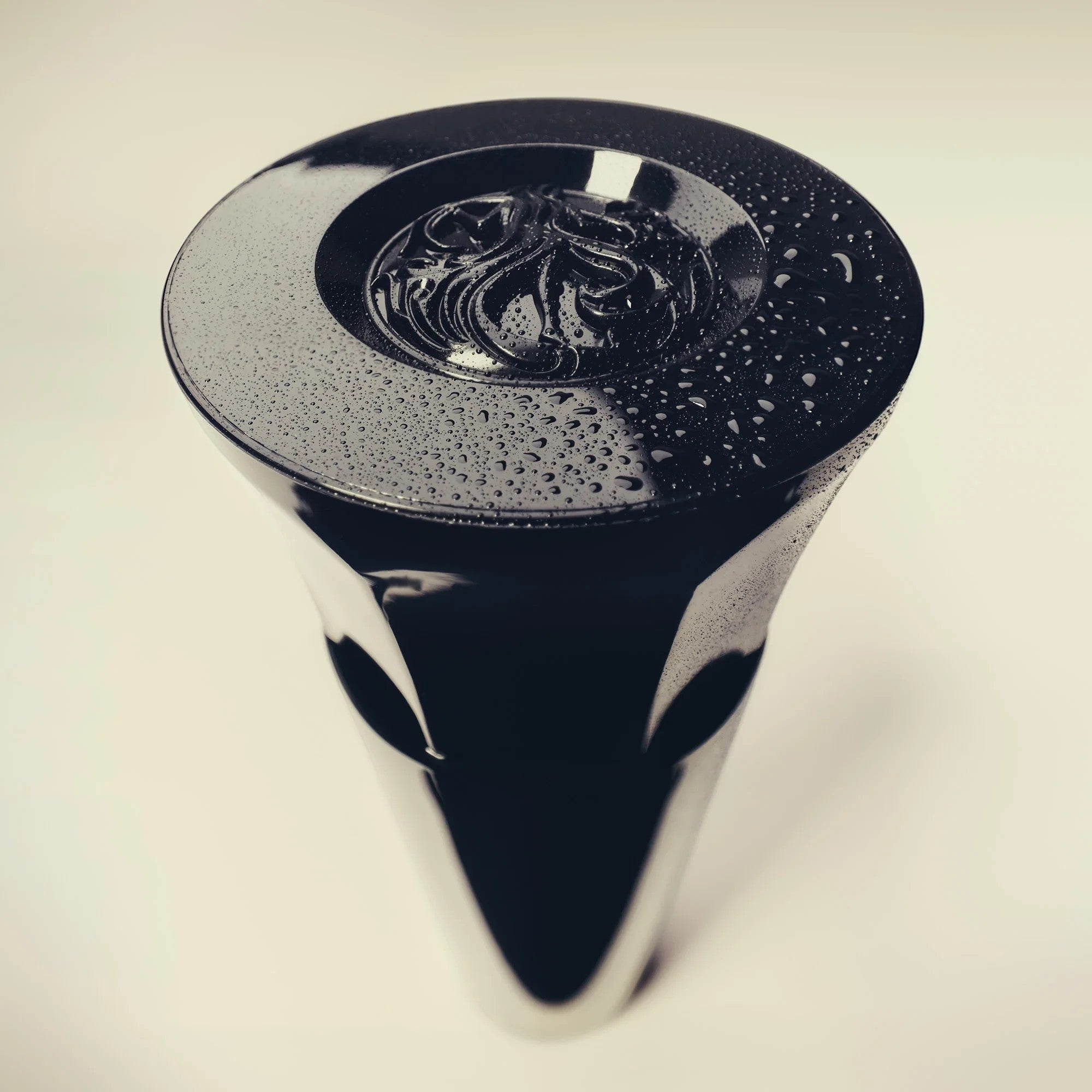 Shop Rescue Spa Royal Blowout Heat Styling Spray bottle cap with water droplets on a sleek black surface