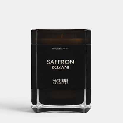 Shop Rescue Spa Saffron Kozani scented candle in a sleek black glass jar with minimalist white typography.