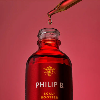 Shop Rescue Spa Philip B. Scalp Booster Pre-Wash serum in a red glass bottle with a gold dropper on a red background.